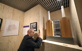 A photograph of a visitor taking a photo of an artwork at Tate Liverpool + RIBA North