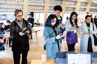 Attendees at the Lives of Net Art workshop day use their phones to interact with one of the exhibits