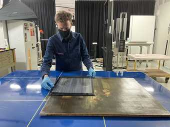 Person preparing a photograph for x-ray photography in the photo dept at Tate