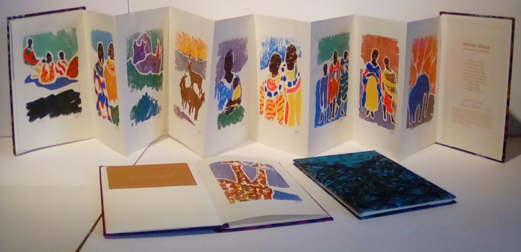 A series of artistic illustrations of African traditions on the pages of a book