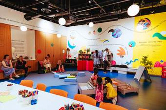 Story Space at Tate Britain - a colourful room with books - people reading and making art