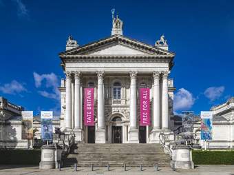 Tate Britain building against a bright blue sky