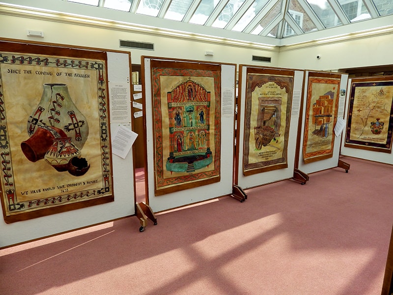 A gallery display of large pieces of artwork