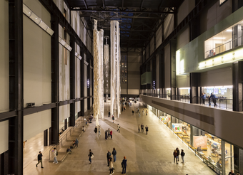 A large hall with people and an art installation